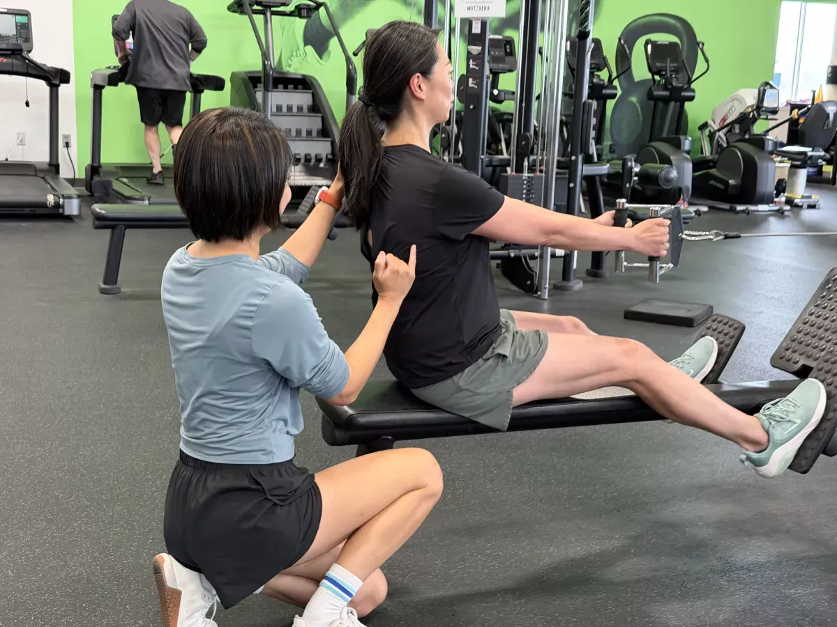 Bonnie assisting a client through a seated exercise